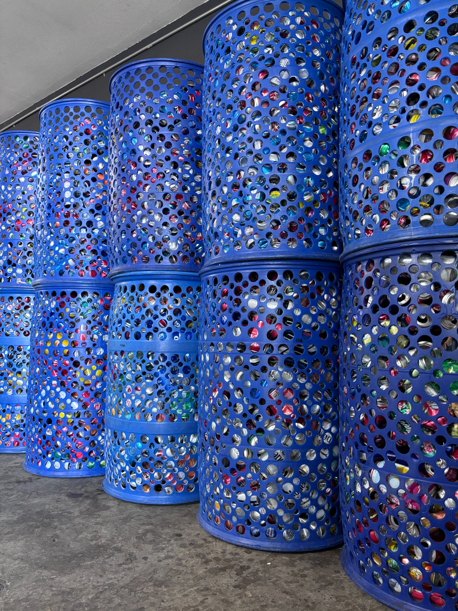 Sorted CRV cans in organized blue bins