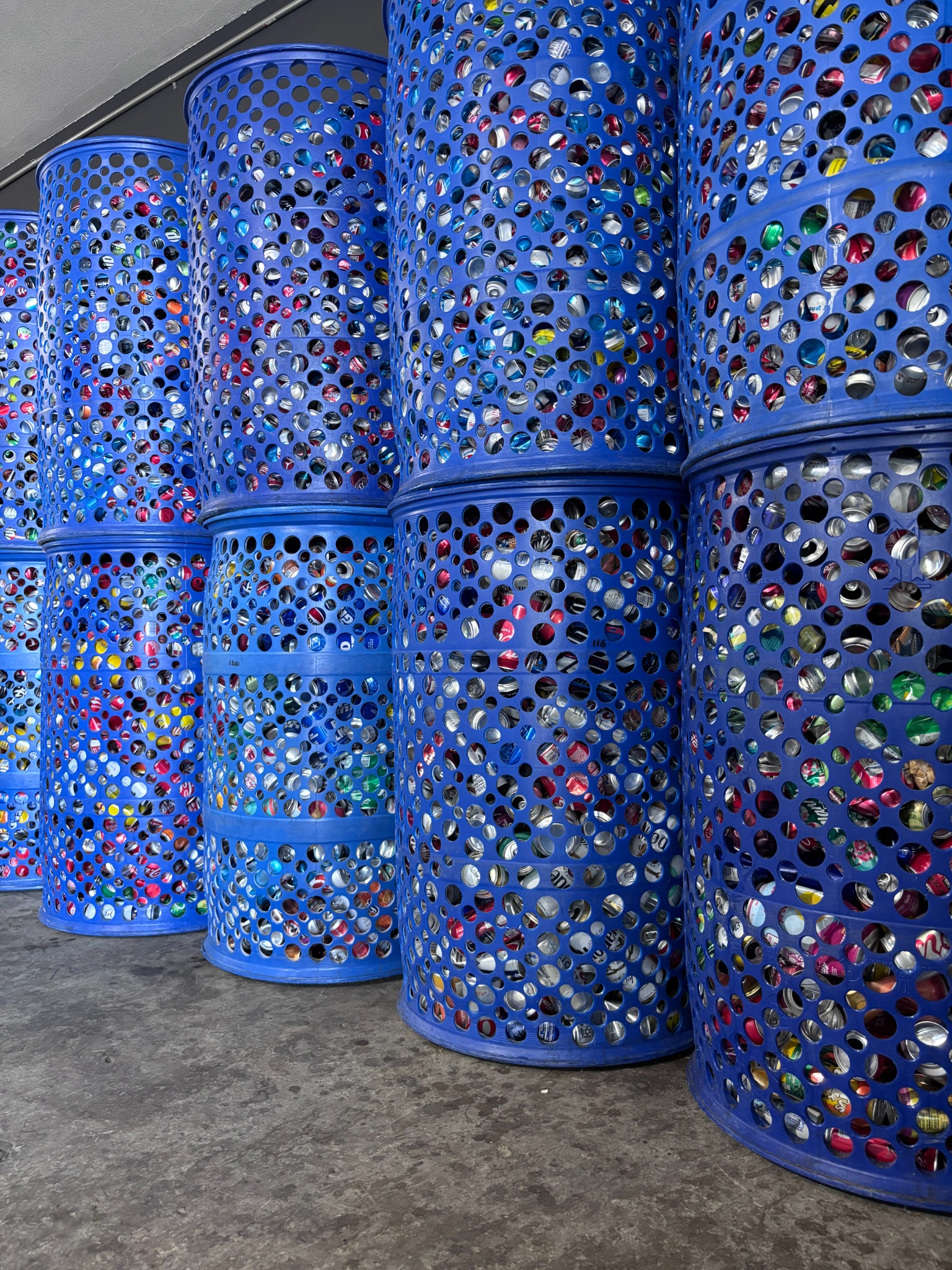 Rows of organized blue bins filled with sorted CRV containers